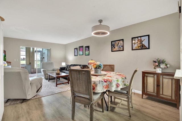 dining space featuring light wood-type flooring