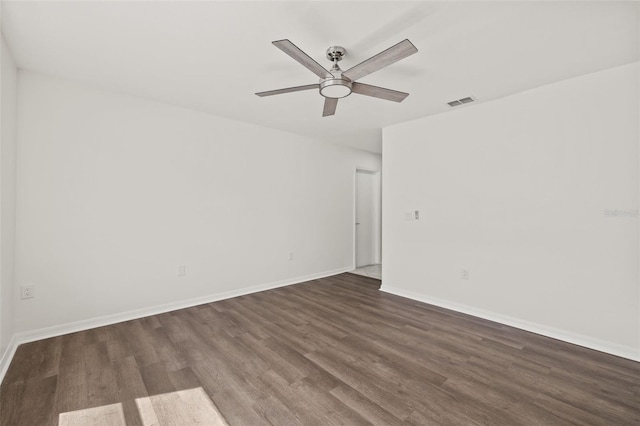 unfurnished room featuring dark hardwood / wood-style flooring and ceiling fan