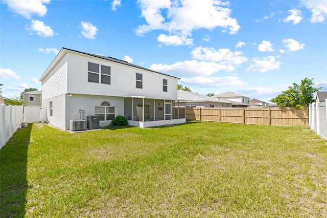 back of house with a sunroom and a yard