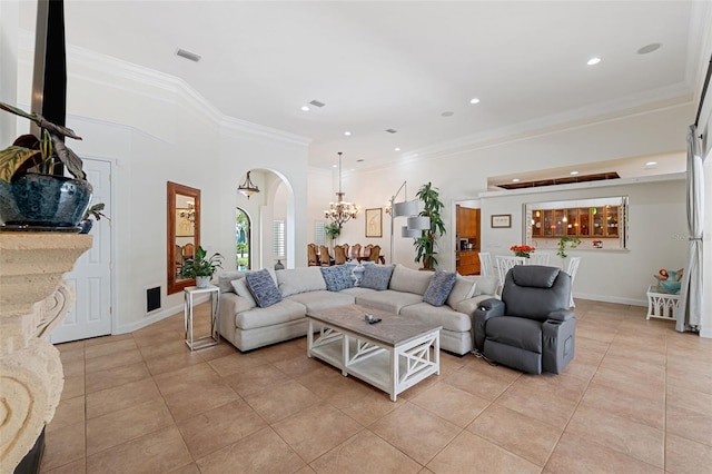 living room with light tile patterned floors and crown molding