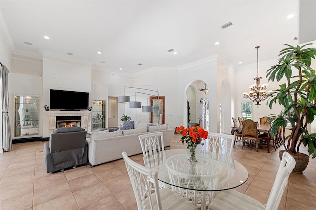 tiled dining room featuring an inviting chandelier and ornamental molding