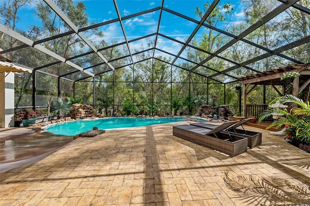 view of pool featuring glass enclosure, a jacuzzi, and a patio area