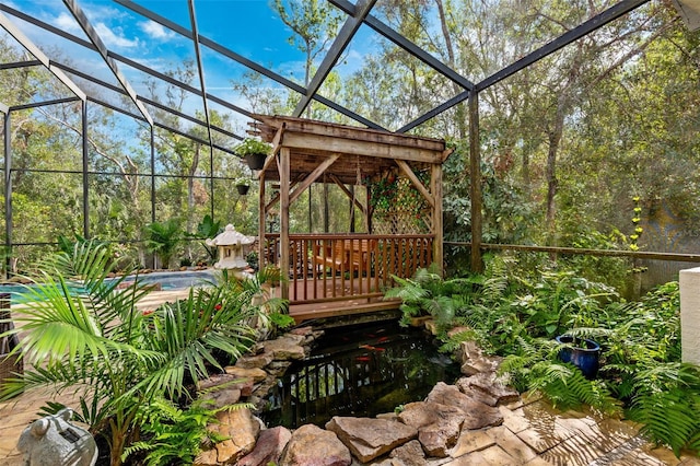 view of patio / terrace with glass enclosure and a gazebo