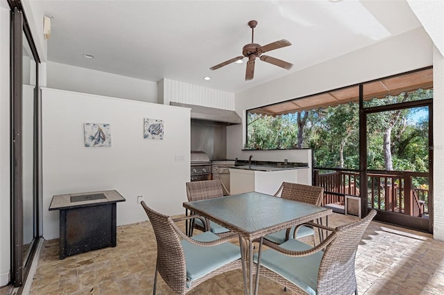 dining area with ceiling fan and sink