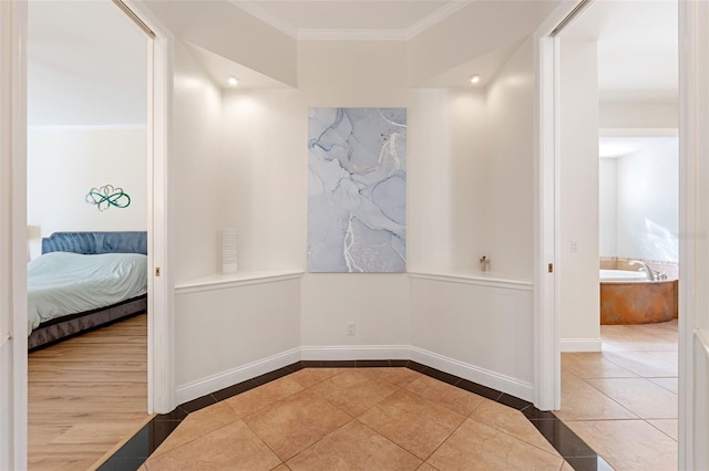 hall featuring ornamental molding and tile patterned floors