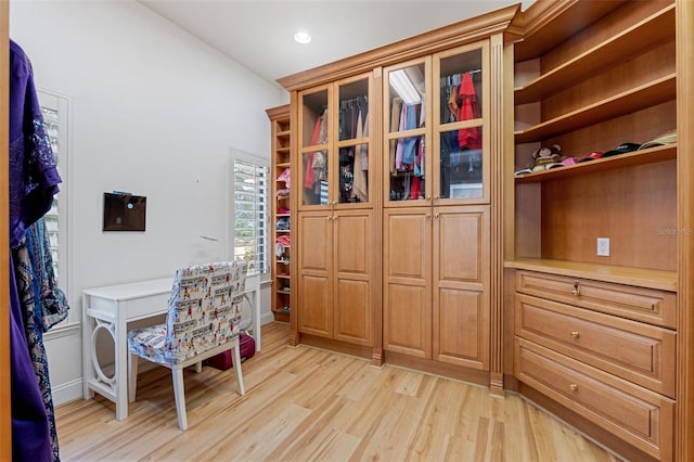 home office with light hardwood / wood-style flooring