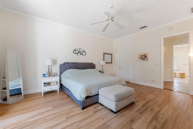 bedroom featuring light hardwood / wood-style floors, ceiling fan, and ornamental molding