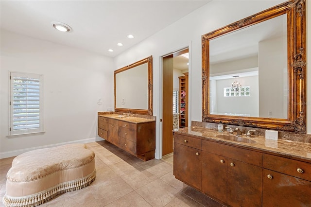 bathroom featuring vanity, tile patterned floors, and a notable chandelier