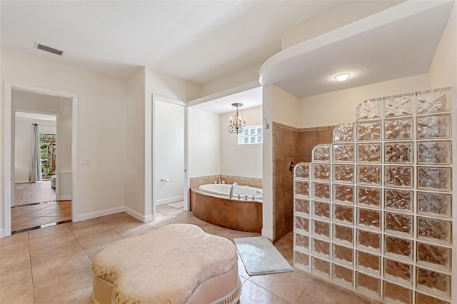 bathroom featuring a chandelier, tile patterned floors, and plus walk in shower