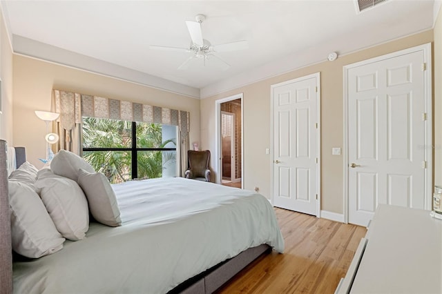 bedroom featuring light wood-type flooring and ceiling fan