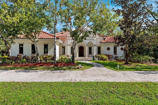 mediterranean / spanish-style house featuring a front yard