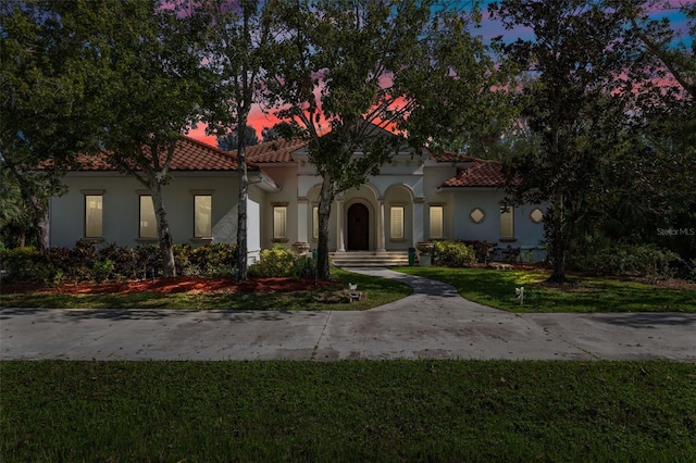 mediterranean / spanish-style home featuring a yard