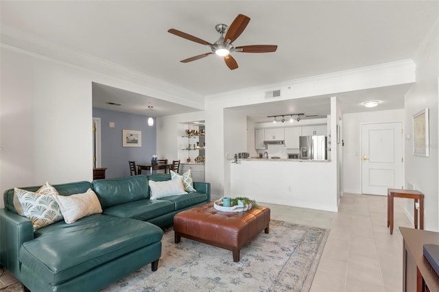 living room with ornamental molding, ceiling fan, and light tile patterned flooring