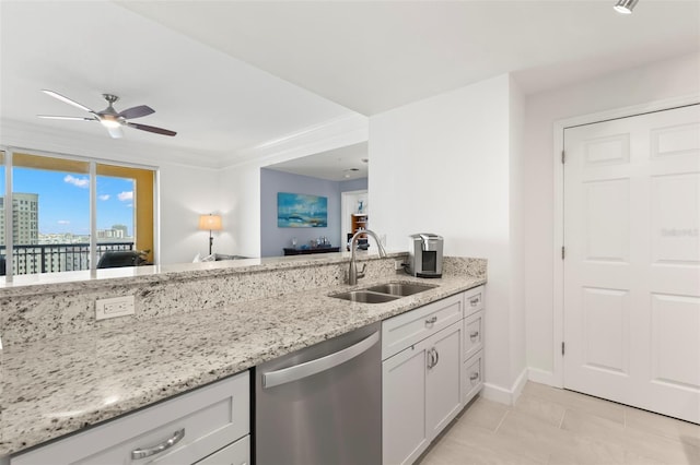 kitchen with dishwasher, white cabinets, sink, ceiling fan, and light stone countertops