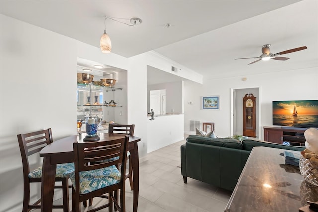 tiled dining room with ceiling fan