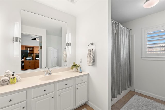 bathroom with walk in shower, vanity, tile patterned flooring, and ceiling fan