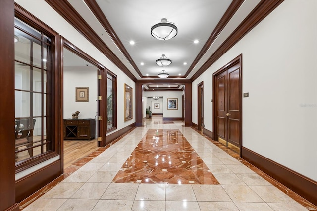 hallway with french doors, light tile patterned floors, and crown molding