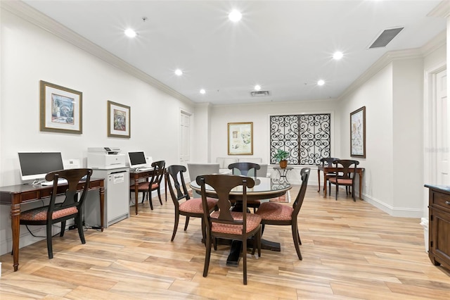 dining space with light hardwood / wood-style floors and ornamental molding