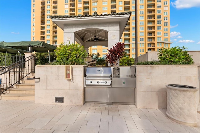 view of patio / terrace with a grill, area for grilling, and ceiling fan