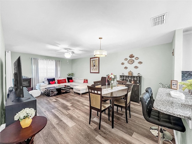 dining room featuring hardwood / wood-style floors and ceiling fan