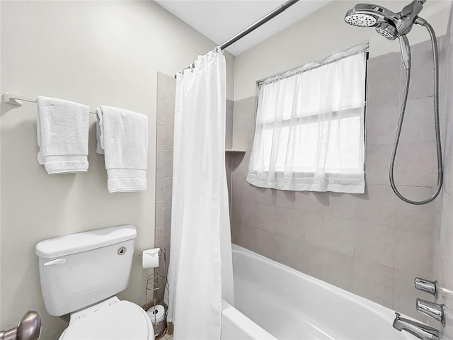 bathroom featuring shower / bath combination with curtain and toilet