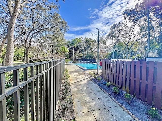 2920 Star Apple Ct, Palm Harbor, FL 34684 - view of pool featuring fence and view of wooded area