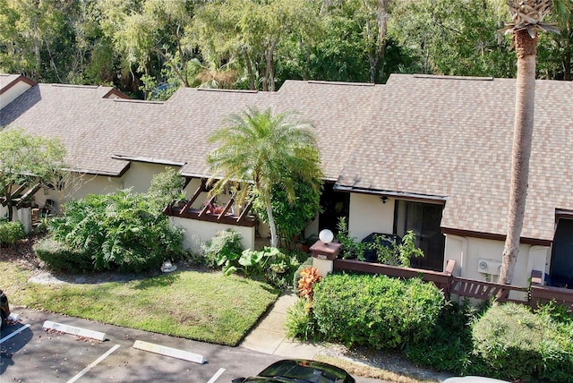 2920 Star Apple Ct, Palm Harbor, FL 34684 - view of front facade with a shingled roof, stucco siding, and uncovered parking