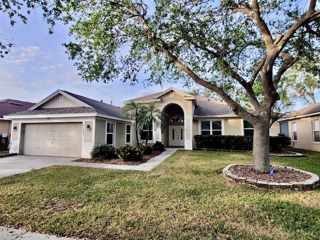 ranch-style house featuring a front yard and a garage