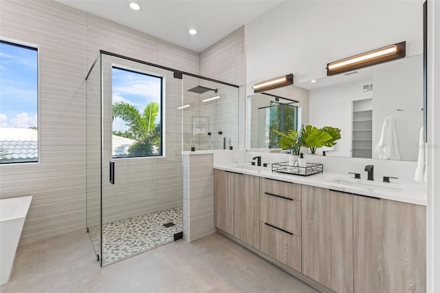 bathroom with concrete flooring, vanity, and an enclosed shower