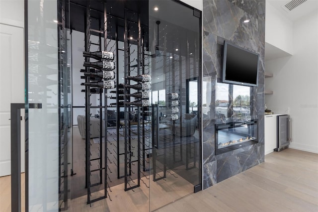 wine area featuring hardwood / wood-style flooring and wine cooler