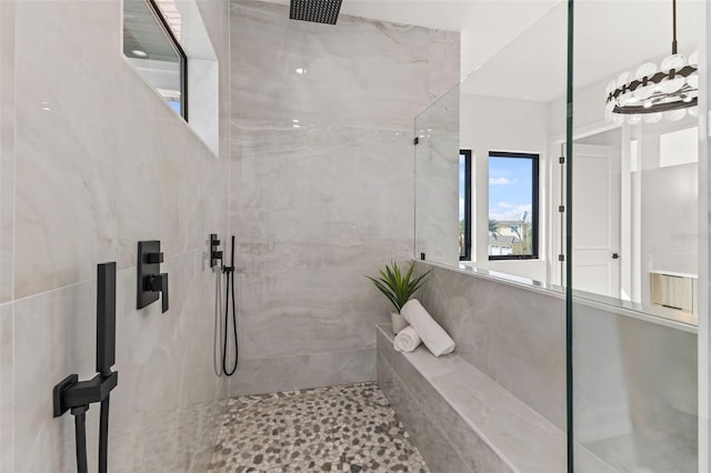 bathroom with a tile shower