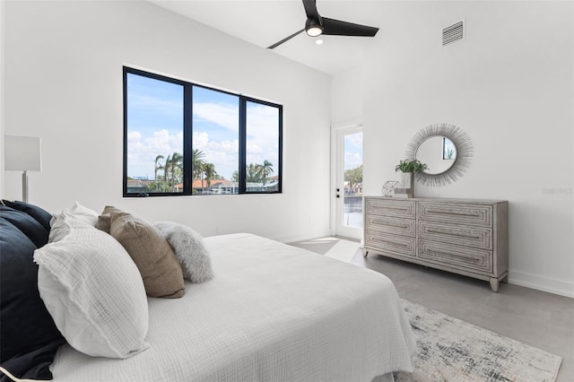 bedroom featuring visible vents, access to exterior, concrete floors, baseboards, and ceiling fan