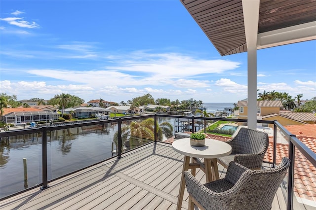 balcony featuring a residential view and a water view