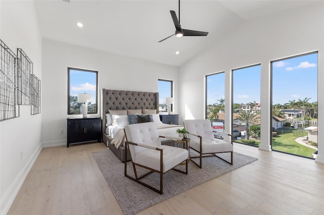 bedroom featuring high vaulted ceiling, recessed lighting, light wood finished floors, baseboards, and access to exterior