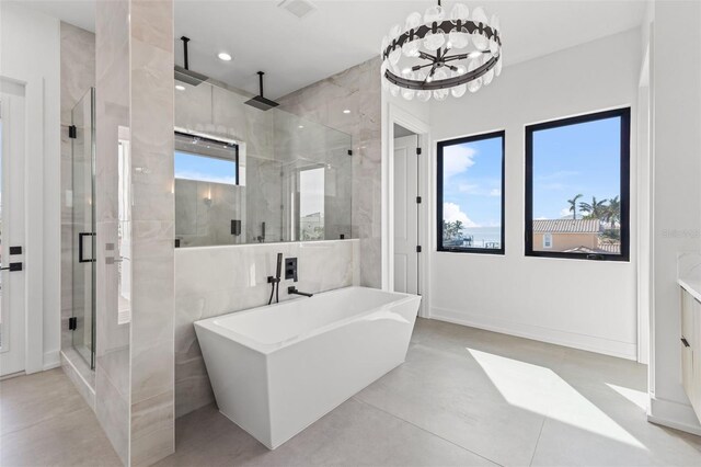 bathroom featuring visible vents, an inviting chandelier, recessed lighting, a freestanding bath, and a shower stall