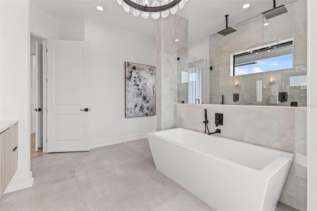 bathroom with a freestanding tub, recessed lighting, a shower stall, baseboards, and vanity