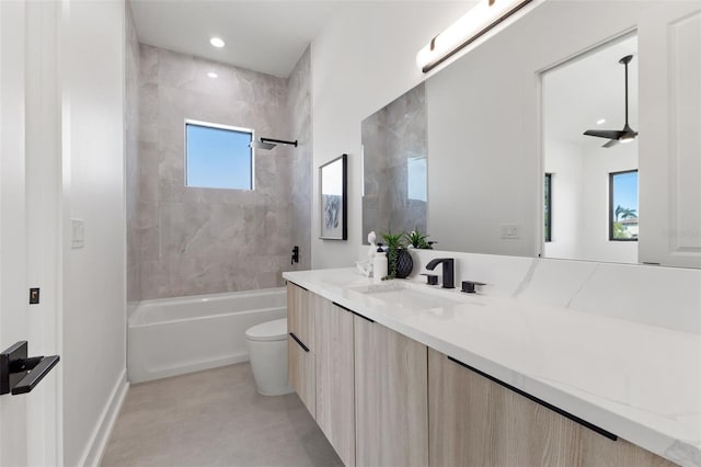 bathroom featuring vanity, recessed lighting, ceiling fan, bathing tub / shower combination, and toilet