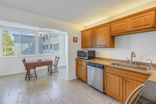 kitchen featuring light tile patterned floors, stainless steel appliances, ceiling fan, and sink