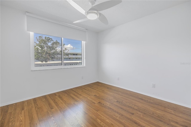 unfurnished room with wood-type flooring and ceiling fan