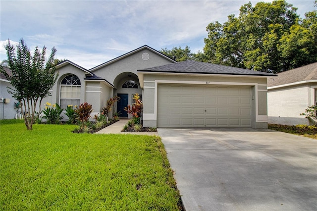 ranch-style home featuring a garage and a front lawn