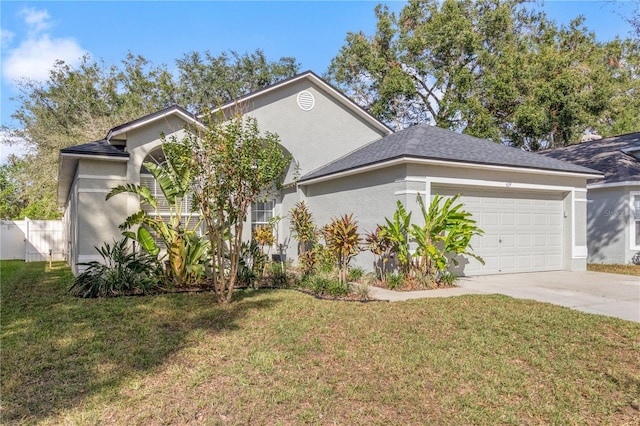 view of front of house with a front yard and a garage