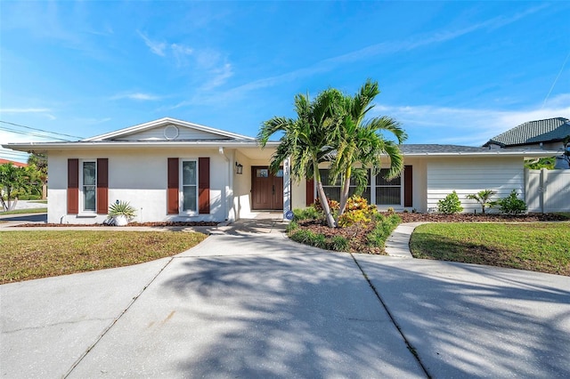 ranch-style home with a front lawn