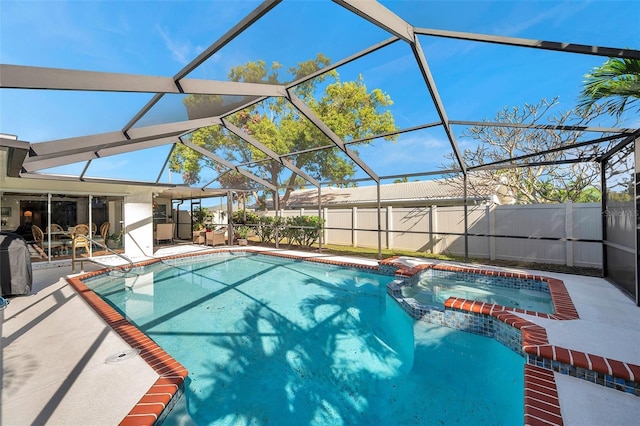 view of swimming pool with a lanai and a patio area