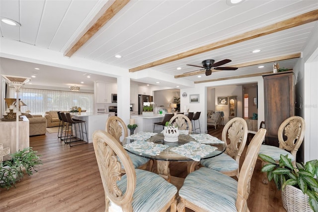 dining room featuring light wood-style floors, recessed lighting, beamed ceiling, and ceiling fan