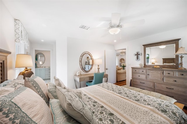 bedroom featuring visible vents, ceiling fan, and ensuite bathroom