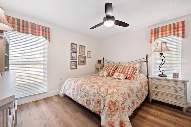 bedroom featuring ceiling fan, baseboards, and dark wood-type flooring