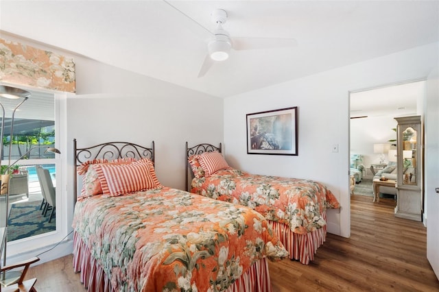 bedroom with access to exterior, ceiling fan, and wood finished floors