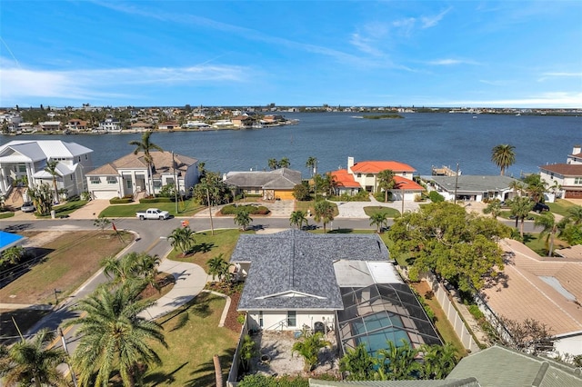 drone / aerial view featuring a water view and a residential view