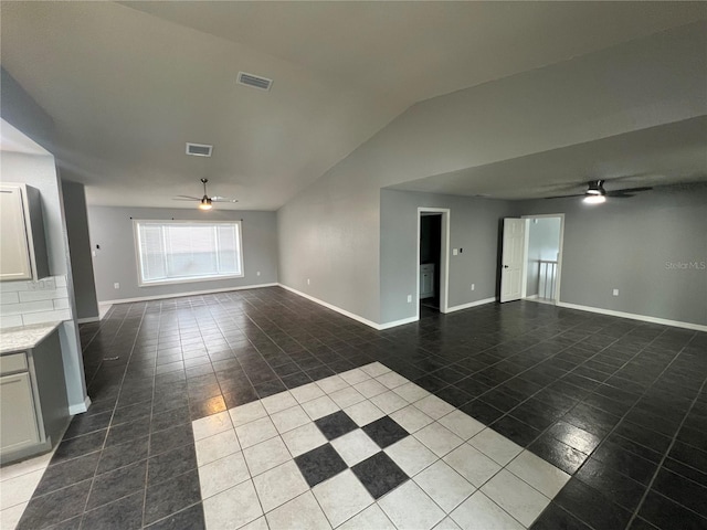 unfurnished living room with lofted ceiling, ceiling fan, and tile patterned floors