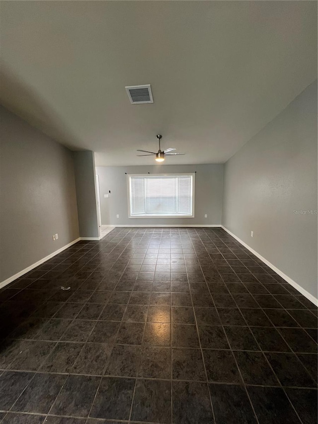 tiled empty room with ceiling fan